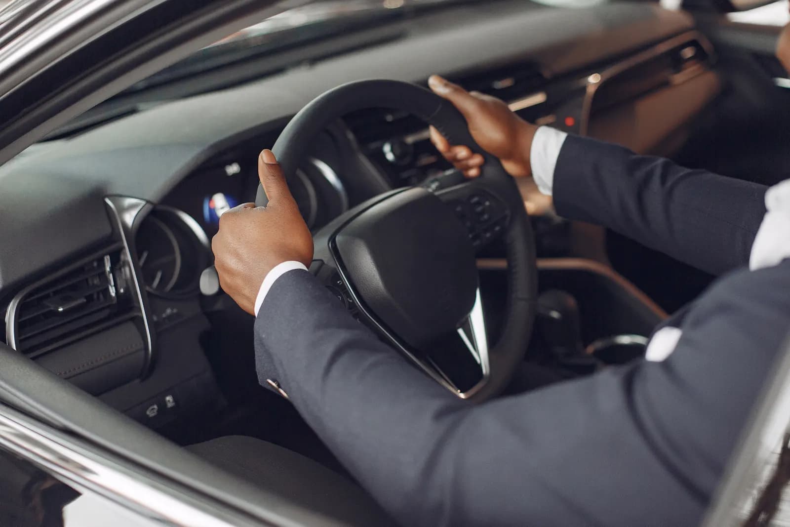 A passenger seated in the cabin of a chauffeur-driven car