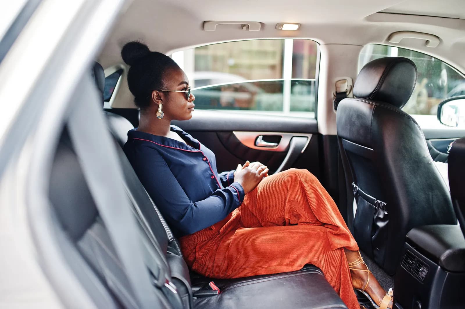 An executive passenger in the leather cabin of an SUV