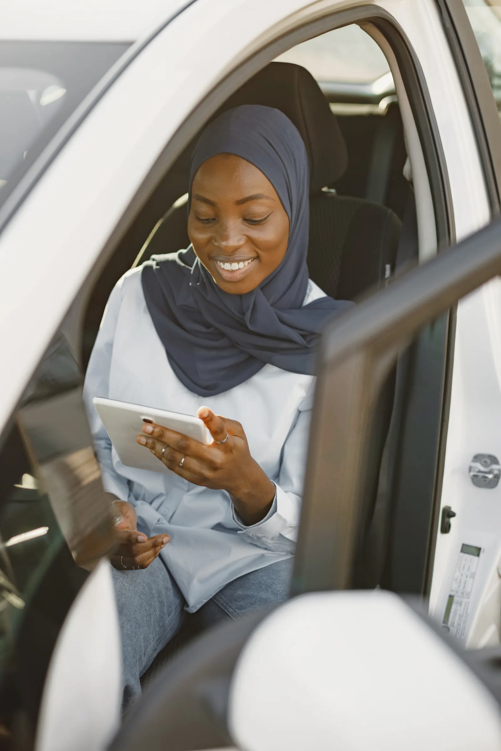 A professional working from a hire car during a longer assignment in Ghana