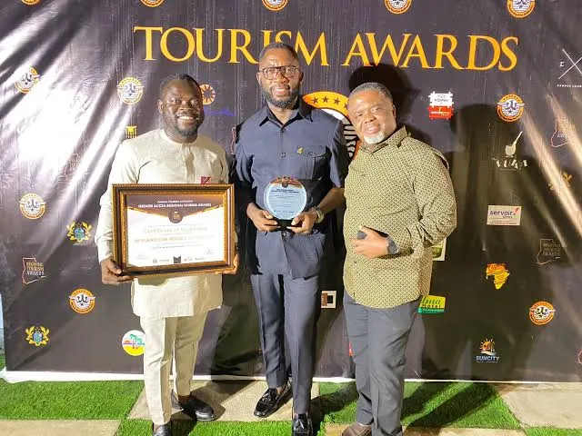 Three men holding a Greater Accra Regional Tourism Awards certificate naming Nii Plants