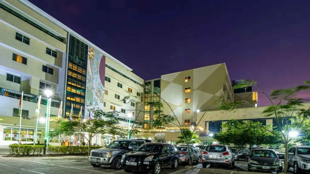 Night exterior and parking at a partner hotel used for Nii Plants car-hire pickup