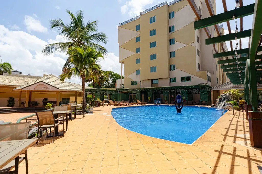 Courtyard swimming pool at a partner hotel used for Nii Plants car-hire pickup